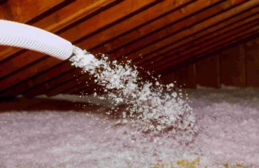 Blown-in insulation being added to an attic floor through a hose